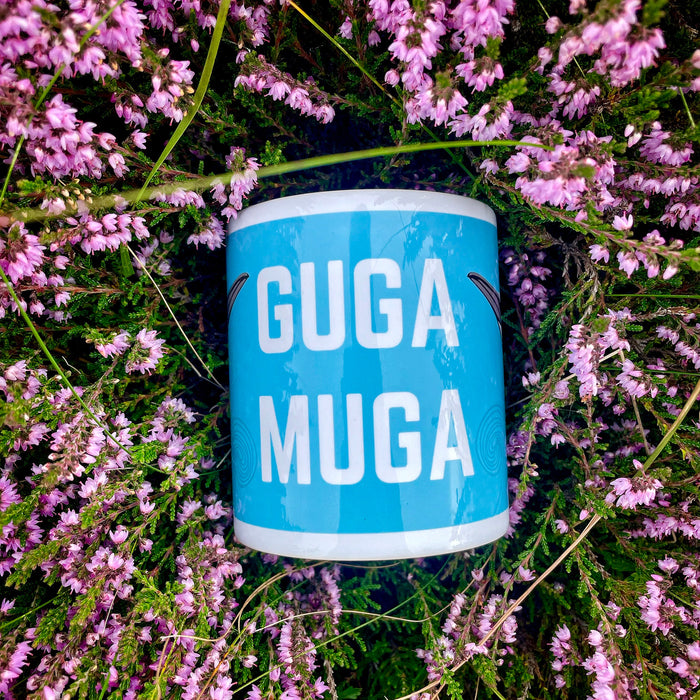 mug shown lying outside surrounded by scottish heather in bloom