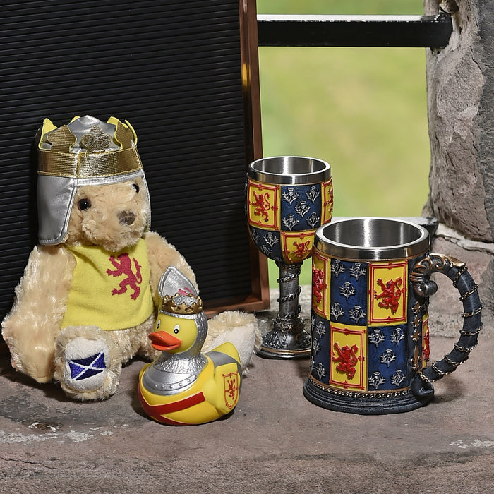 image showing bear with other items from the heraldic range including rubber duck, goblet and tankard in the window recess of a castle wall