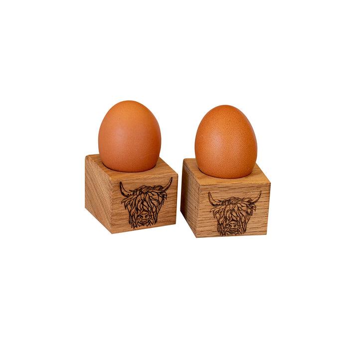 set of 2 highland cow motif square egg cups shown with boiled eggs