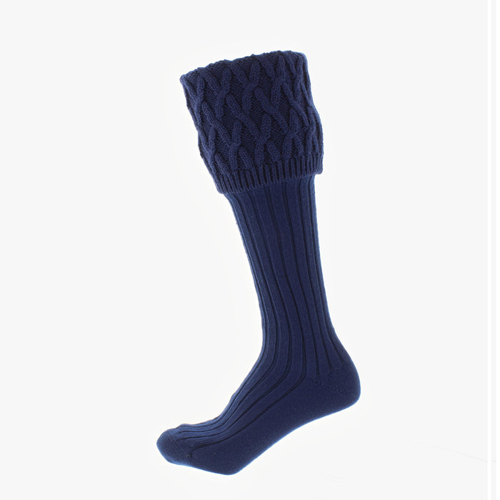 Rannoch Socks Navy with knitted pattern shown at an angle with ribbed leg design and interlocking top fold over for wellies