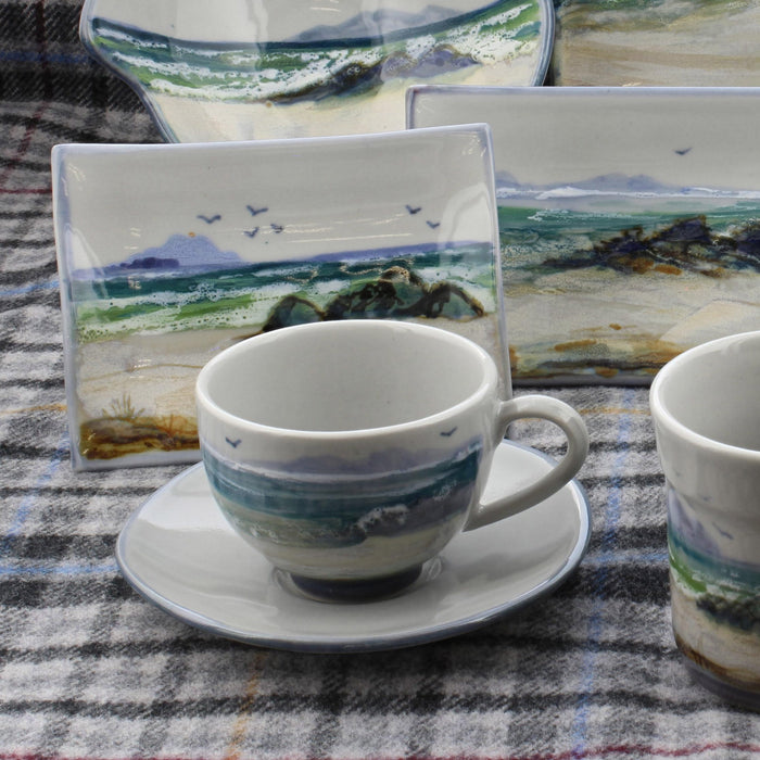 hand painted scottish stoneware cup and saucer shown with other items from the seascape collection